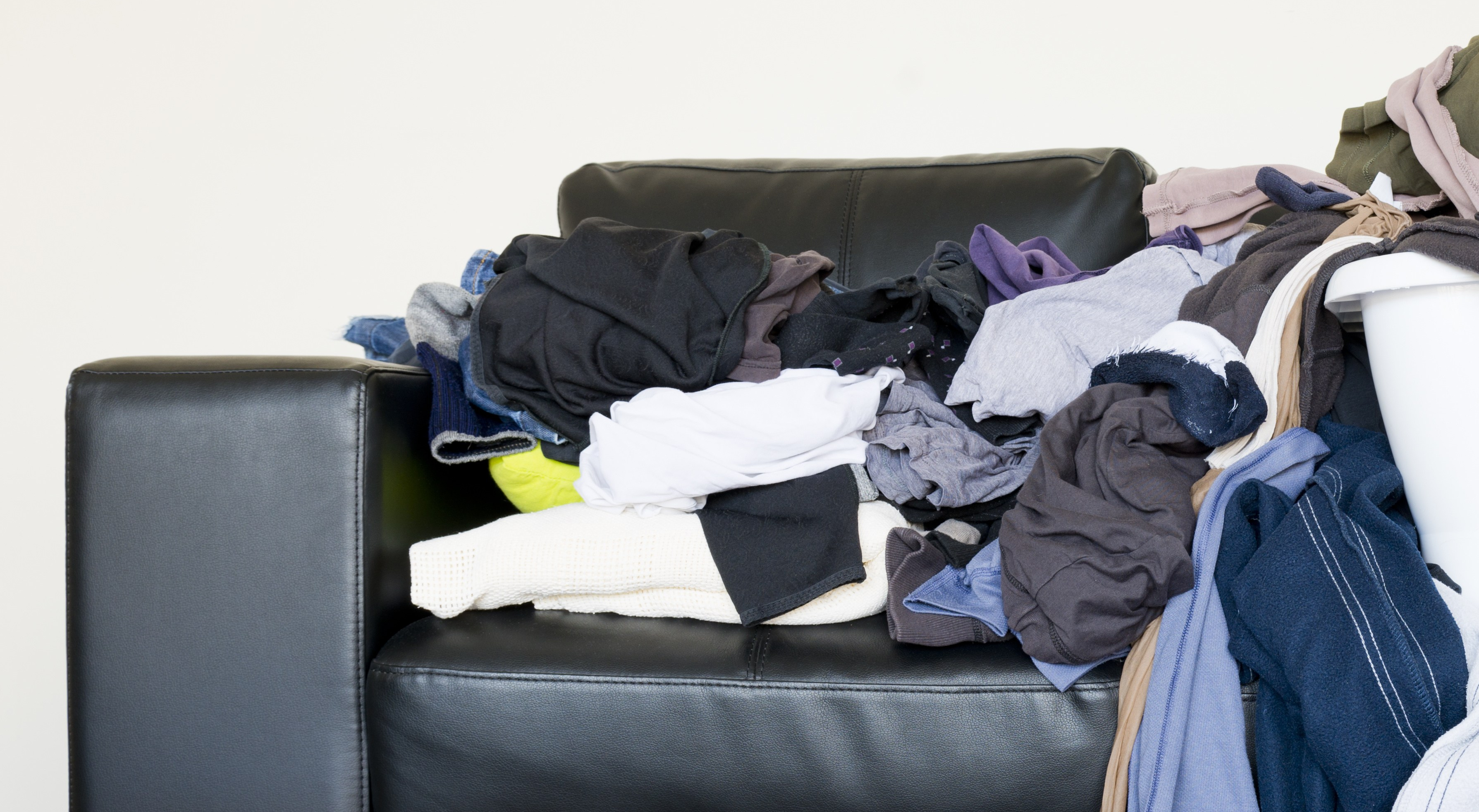 laundry piled on couch